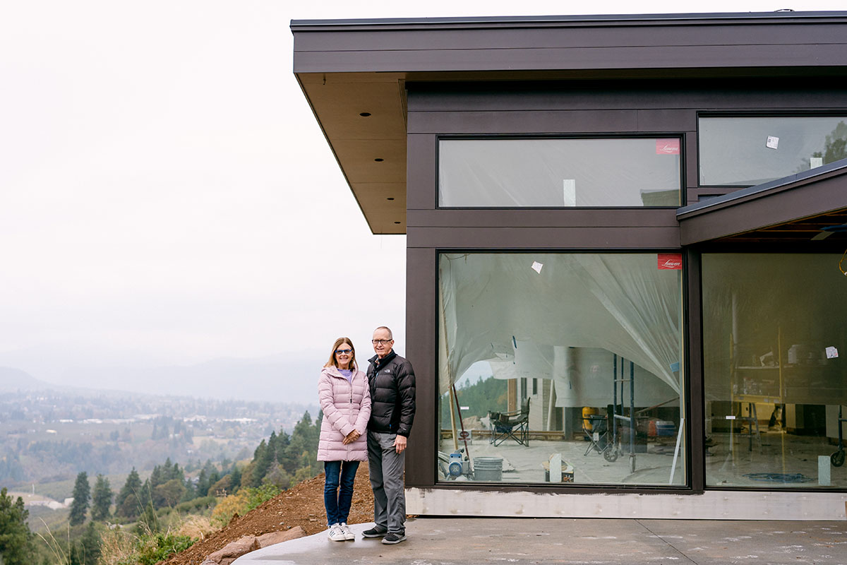 Couple in front of their new home under construction