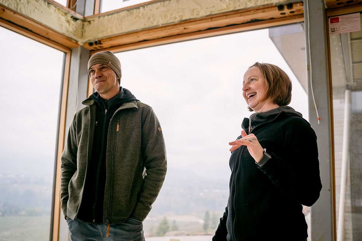 Jon and Bre talking to client in home under construction