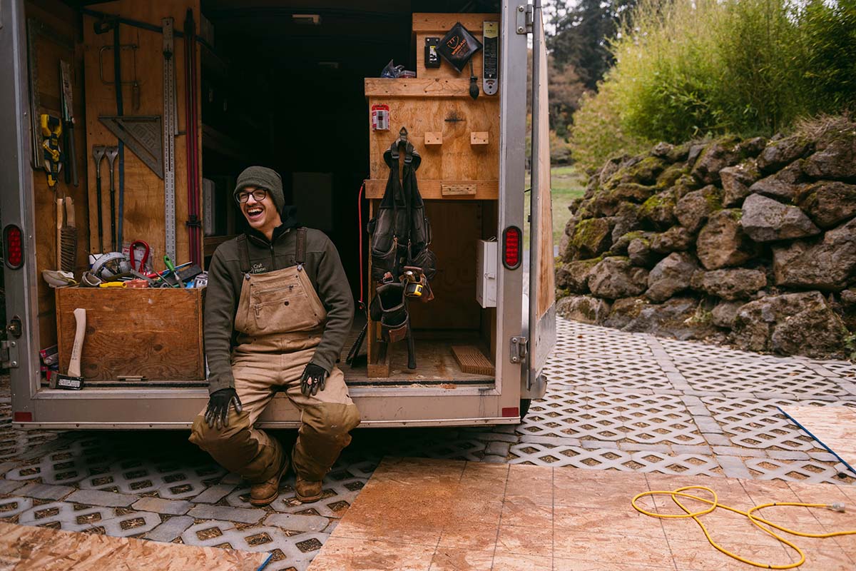 Worker sitting in trailer laughing